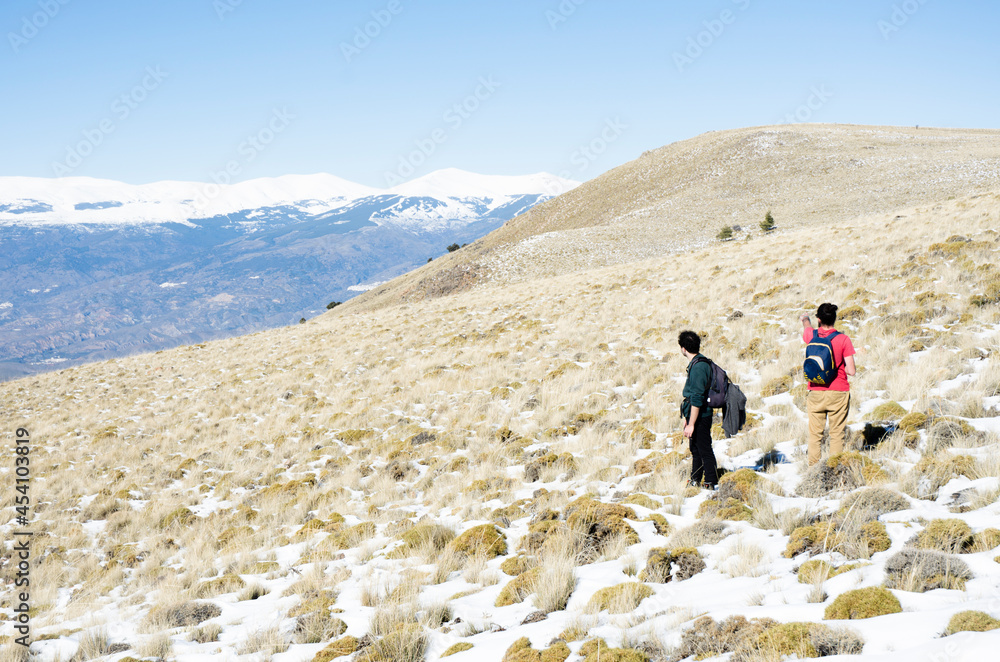 two men in the snowy mountains