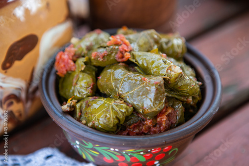 Dolma.Traditional romanian cuisine stuffed cabbage leaves with minced meat and rice in ceramic dish.