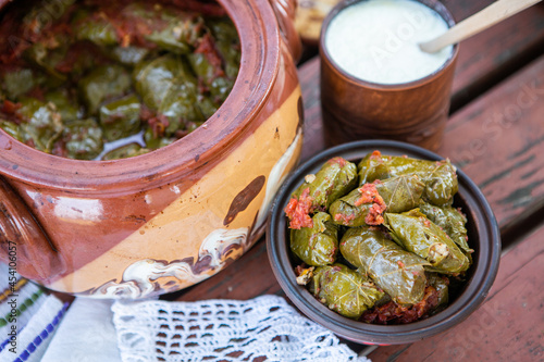 Dolma.Traditional romanian cuisine stuffed cabbage leaves with minced meat and rice in ceramic dish.