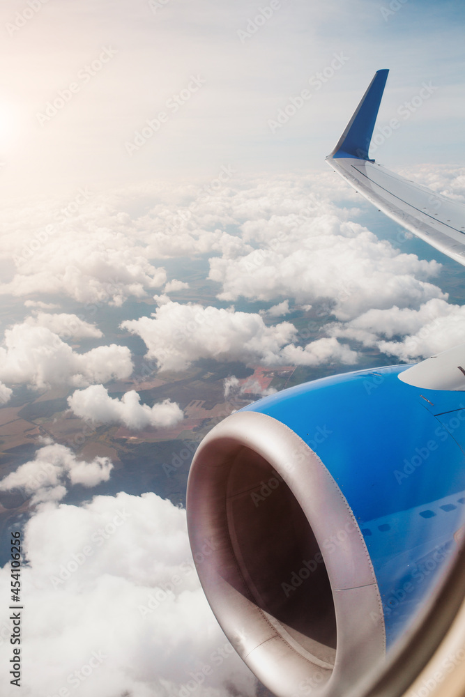 Fototapeta premium Spectacular view from the airplane window of the clouds in the sky - thick dense clouds of a thunderstorm front