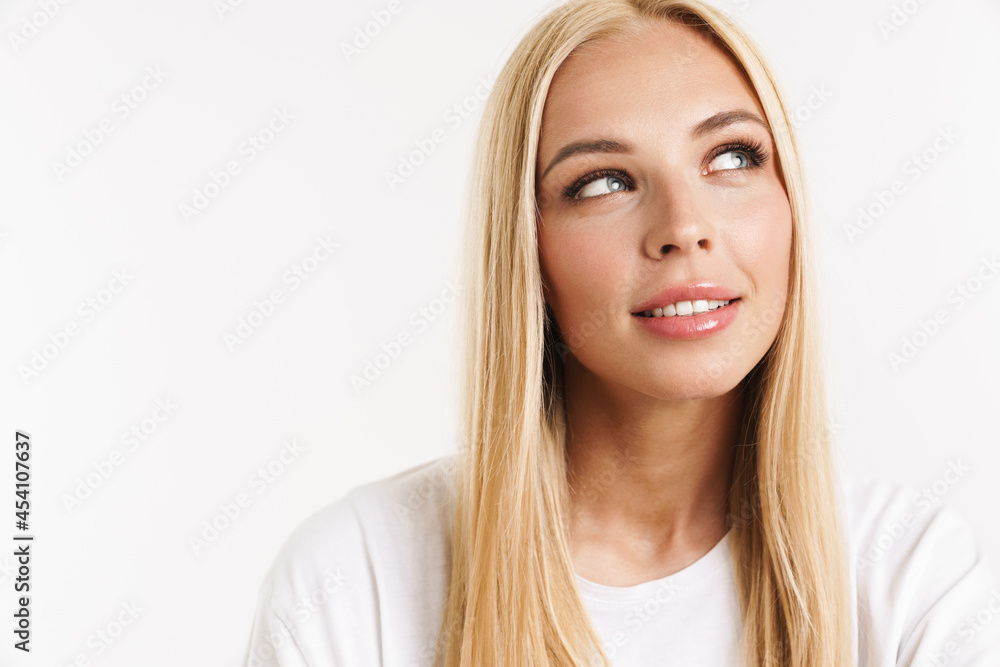 Young blonde woman in t-shirt posing and looking aside Young blonde woman in t-shirt posing and looking aside