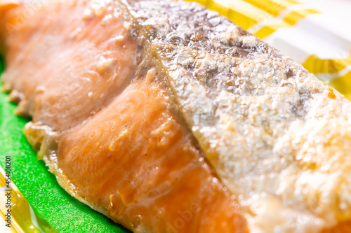 Closeup Japanese style Salmon Grilled with Salt (Shio Sake, or Shio Shake) sold by local supermarket in Japan. The Salmon Sake Fish (Sake or Shake in Japanese) in image on the plastic food container photo