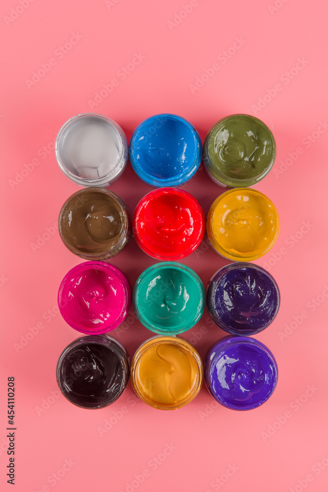 bottle of mixed color paints isolated on pink background bottle of mixed color paints isolated on pink background