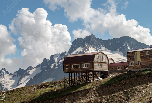 Wooden houses in the mountains. New log cabins cottege in the highlands. Beautiful mountain landscape with obaks