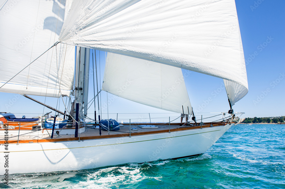 luxury wood yacht sailing under wind

