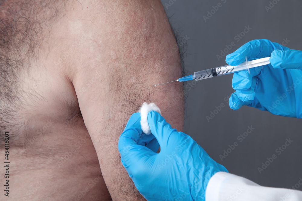 Doctor making injection vaccination to patient. Doctor making injection vaccination to patient.