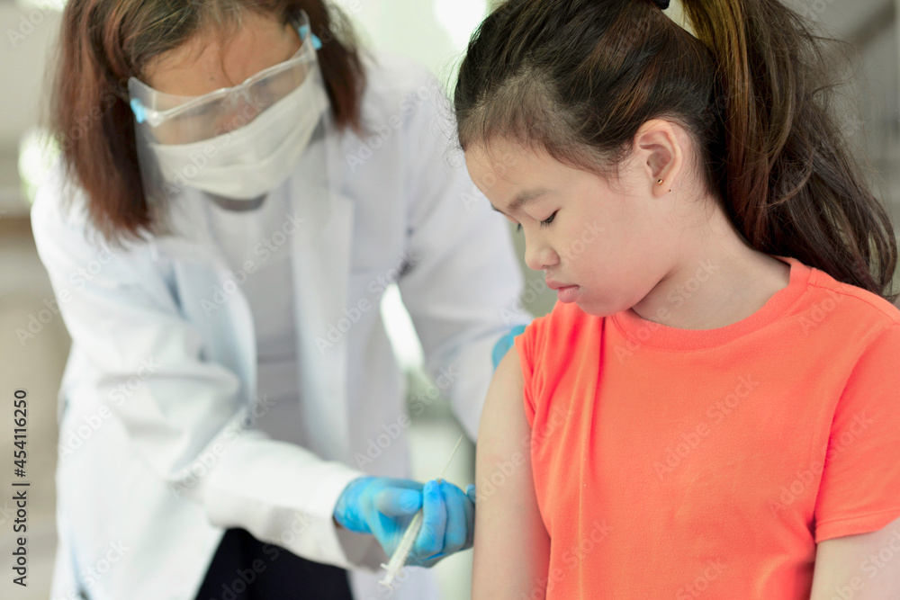 Asian child being vaccinated.Children vaccination by nurse.Medical doctor vaccinating school student in the arm.Paediatrician administrating vaccine to students in clinic.Physician injecting person. Asian child being vaccinated.Children vaccination by nurse.Medical doctor vaccinating school student in the arm.Paediatrician administrating vaccine to students in clinic.Physician injecting person.