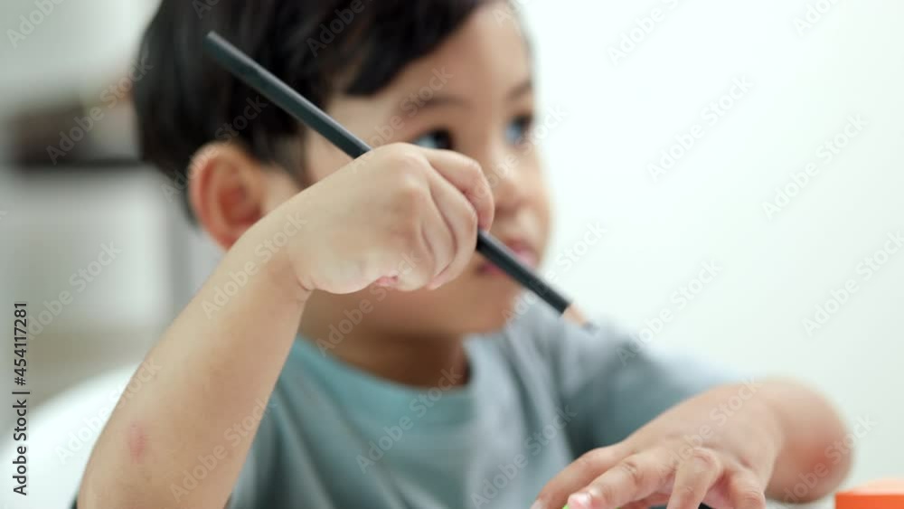 Asian little boy education from home. Developing children's learning before entering kindergarten Practice the skills of playing with wooden toys and drawing and painting.
Asian little boy education from home. Developing children's learning before entering kindergarten Practice the skills of playing with wooden toys and drawing and painting.