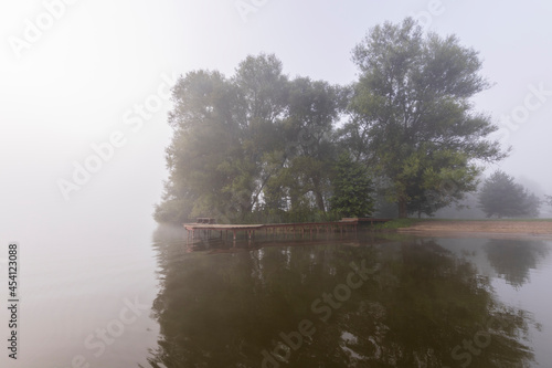 Fog on the river. Mystical landscape at dawn. Early morning. Beautiful dawn in the summer by the river. Scenic landscape in the early morning at sunrise.