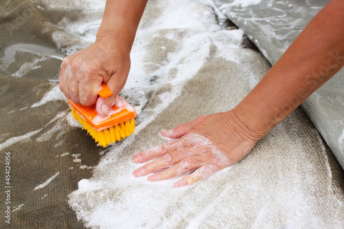 Hand wash carpet. Washing. Close-up. Background.