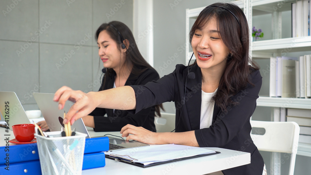 Call center or telemarketing taking notes and answering customer questions. Call center or telemarketing taking notes and answering customer questions.