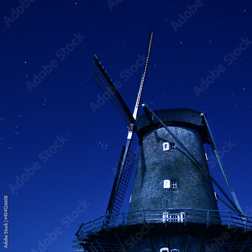 Scenic view of an old windmill on a dark stary stary
