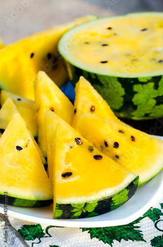 atermelon with yellow pulp on the table photo