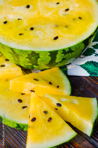 atermelon with yellow pulp on the table photo