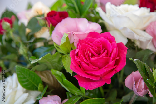 floral arrangement. colorful natural flowers. pink rose in the foreground. blurred background