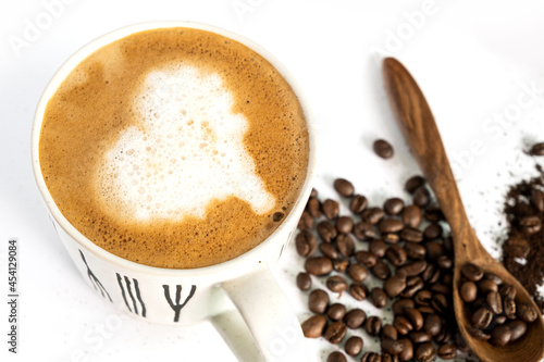hot latte and coffee beans on white background