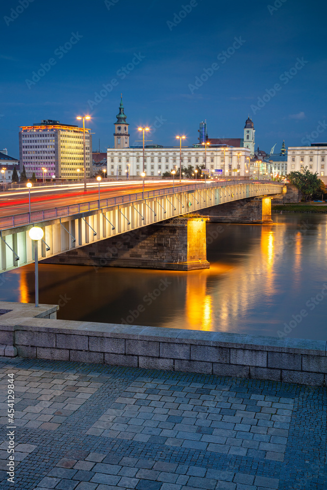 Linz, Austria. Cityscape image of riverside Linz, Austria during twilight blue hour with reflection of the city lights in Danube river.