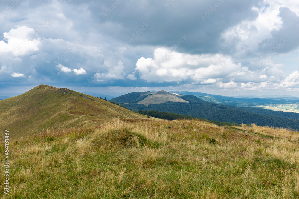 Verkhovyna Watershed Range, Pikui Mountain. Carpathian mountains with grassy slopes and rocks on Pikuy mount. Beautiful mountain landscape in summer