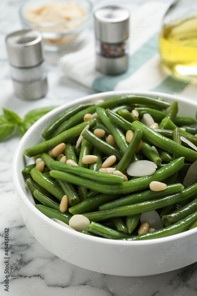 Bowl of tasty salad with green beans on white marble table Bowl of tasty salad with green beans on white marble table