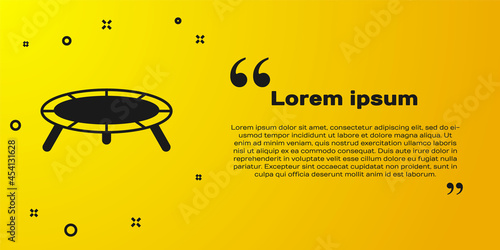 Black Jumping trampoline icon isolated on yellow background. Vector