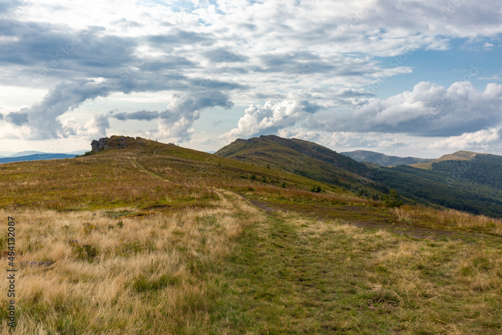 Verkhovyna Watershed Range, Pikui Mountain. Carpathian mountains with grassy slopes and rocks on Pikuy mount. Beautiful mountain landscape in summer Verkhovyna Watershed Range, Pikui Mountain. Carpathian mountains with grassy slopes and rocks on Pikuy mount. Beautiful mountain landscape in summer