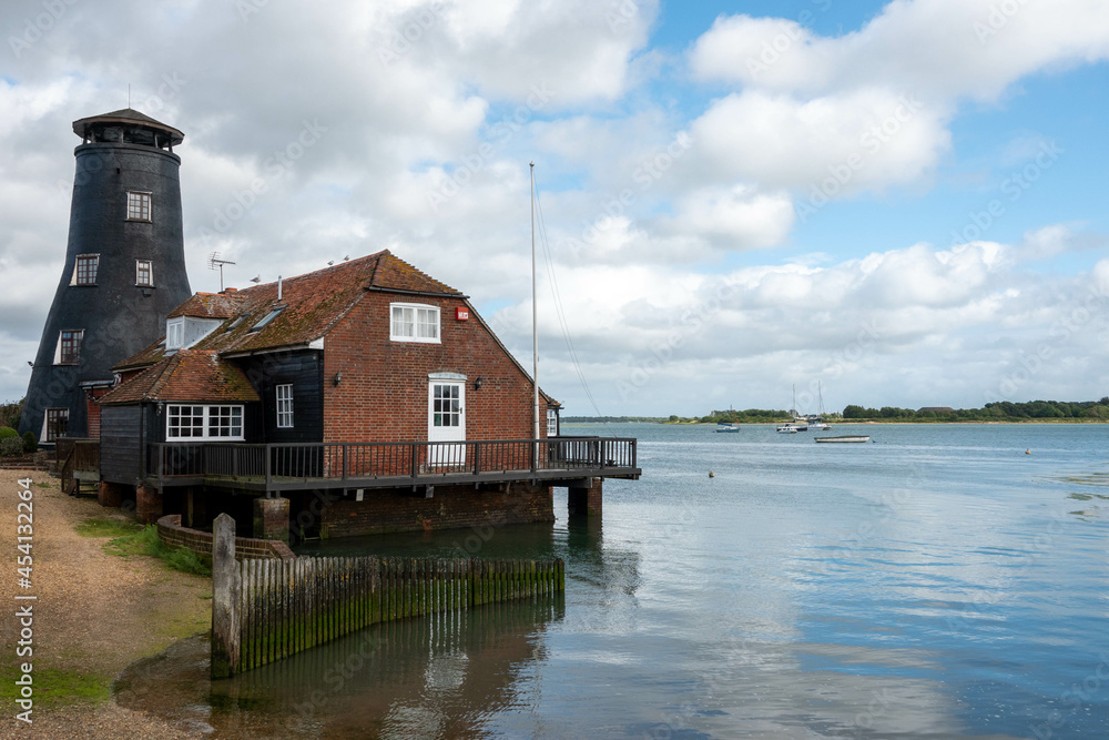  old historic mill at Langstone Harbour Hampshire England reflecting in the sea on a bright summer day