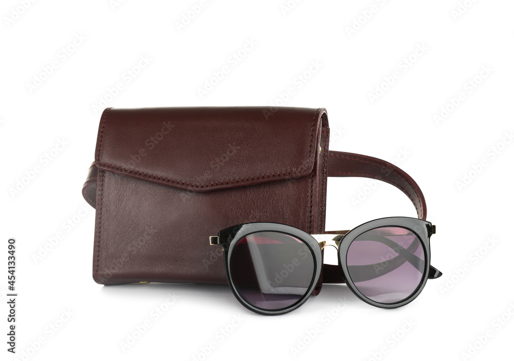 Brown women's leather flap bag and sunglasses on white background Brown women's leather flap bag and sunglasses on white background