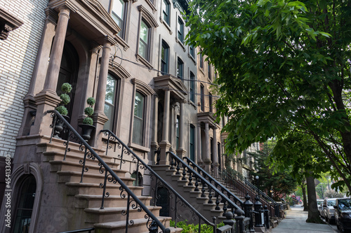 Konstfotografi Row of Beautiful Old Brownstone Homes with Staircases along a Sidewalk in Jersey