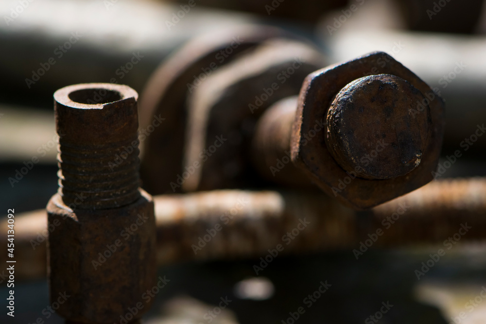old rusty bolt, iron rod with screw threads. Rusted mechanical components. threaded bolt and nut. dismantling concept, difficult to unscrew, non-removable. selective focus, close-up, macro old rusty bolt, iron rod with screw threads. Rusted mechanical components. threaded bolt and nut. dismantling concept, difficult to unscrew, non-removable. selective focus, close-up, macro