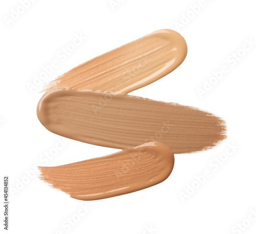 Samples of liquid skin foundation on white background, top view. Space for text