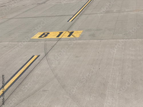 taxiway yellow line B11 on airport runway for gate direction
