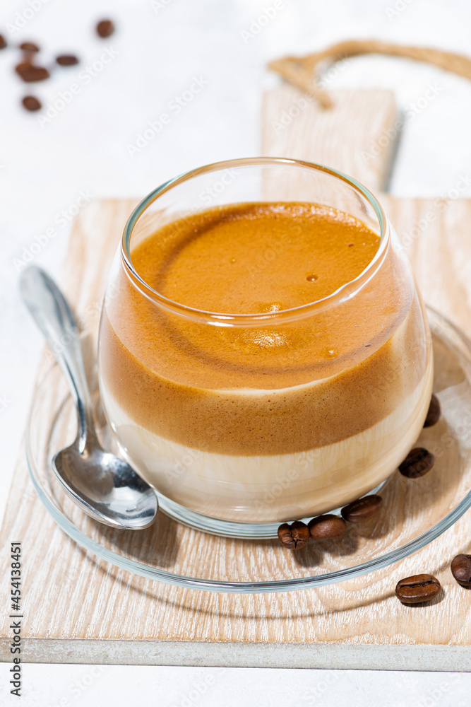 milky coffee with cream foam, vertical top view milky coffee with cream foam, vertical top view