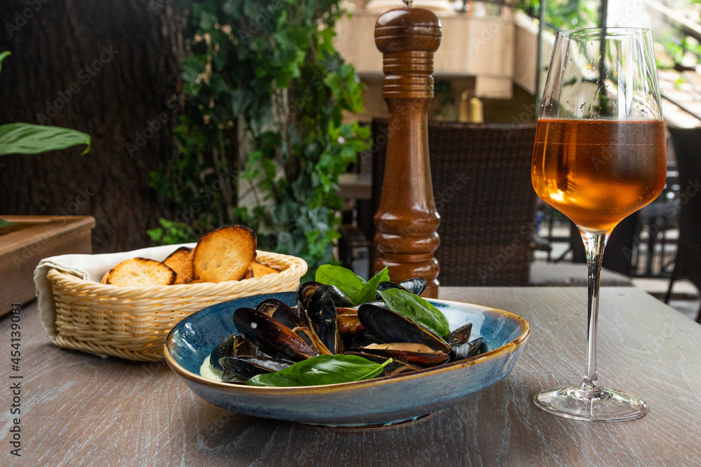 Mussels in a creamy sauce with croutons and a glass of wine Mussels in a creamy sauce with croutons and a glass of wine