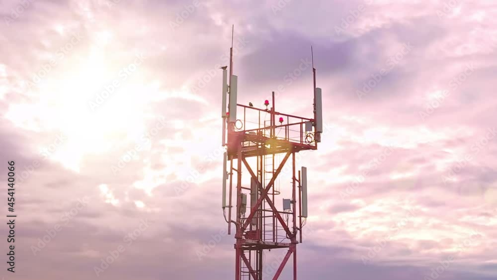 Closeup aerial view to the top of tower with mounted communication equipment