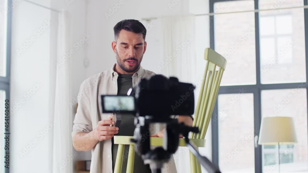 blogging, furniture restoration and home improvement concept - man or blogger showing old wooden chair renovation and recording tutorial video blogging, furniture restoration and home improvement concept - man or blogger showing old wooden chair renovation and recording tutorial video