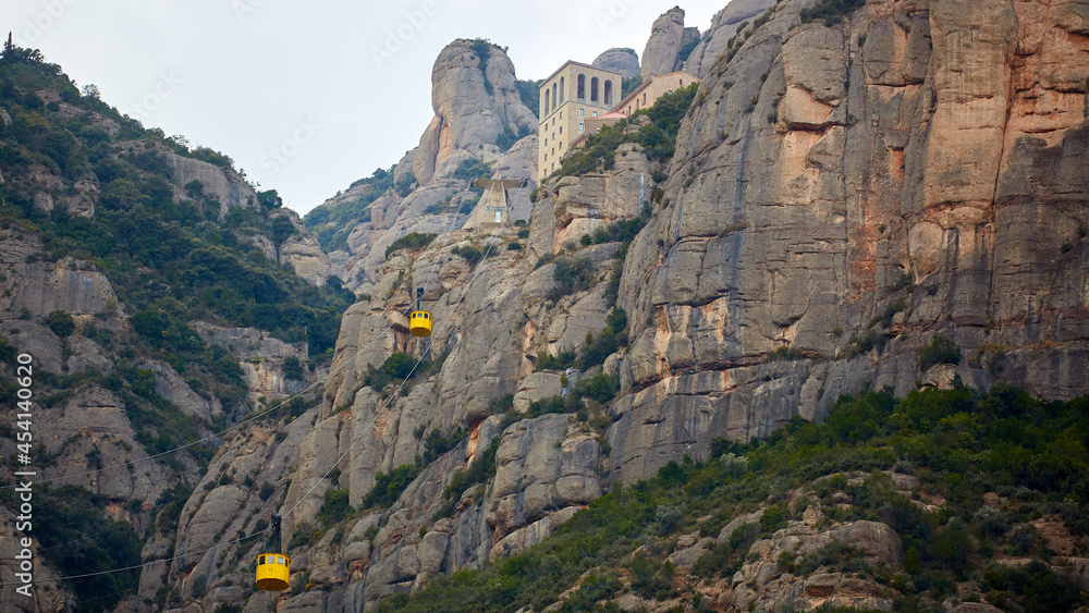 Yellow cable car in the Aeri de Montserrat rise to de Montserrat Abbey near Barcelona, Spain, Catalonia.
