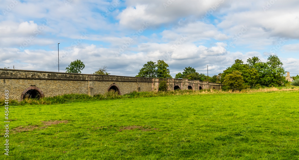 A panorama view of a bridge across the River Nene near at Oundle, UK on a summers day