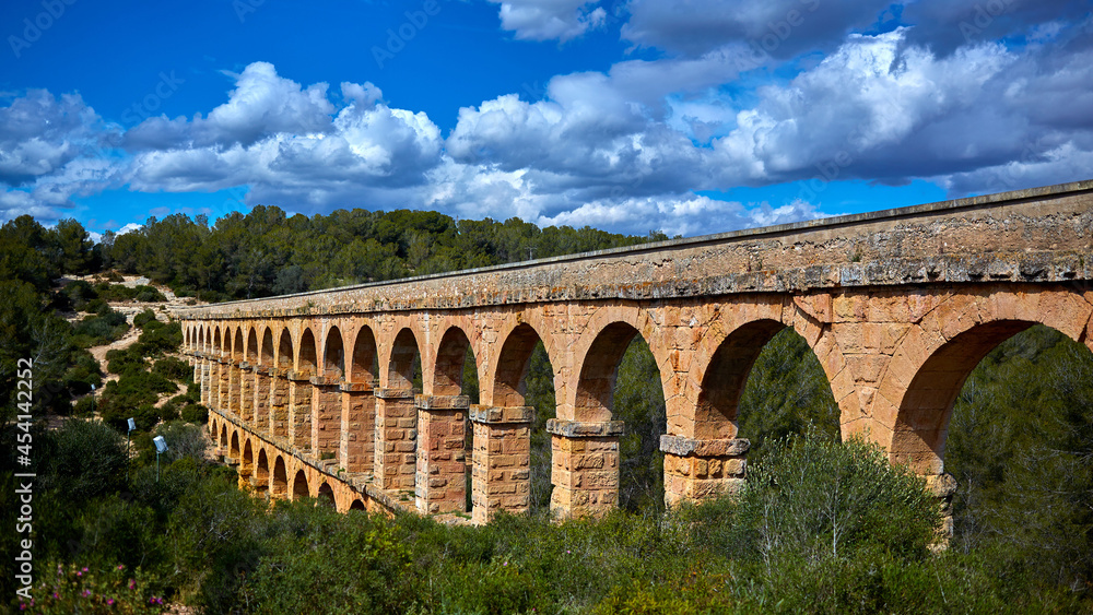 Obraz premium The Ferreres Aqueduct, also Pont del Diable or Devil Bridge, an ancient bridge, part of the Roman aqueduct built to supply water to the ancient city of Tarraco, today Tarragona in Catalonia, Spain.