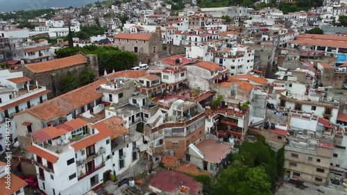 Taxco is a town in the state of Guerrero, famed for Spanish colonial architecture.  Close flight over rooftops. Cinematic photo