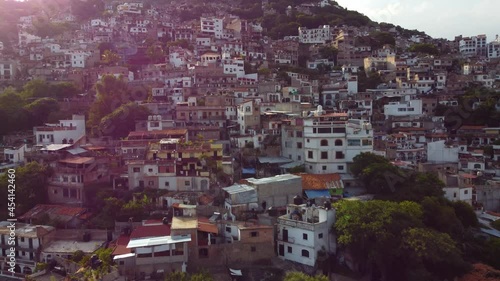 Taxco is a town in the state of Guerrero, famed for Spanish colonial architecture. Climbing the hill from the air. Cinematic with lens flare. photo