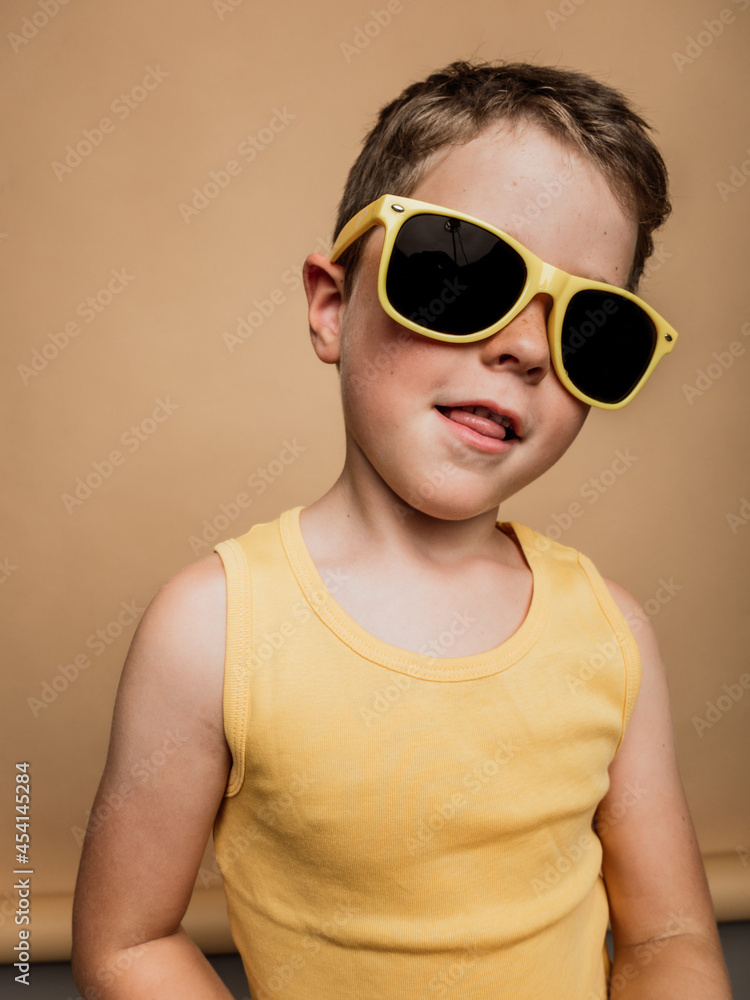 Stylish boy in sunglasses in studio Stylish boy in sunglasses in studio