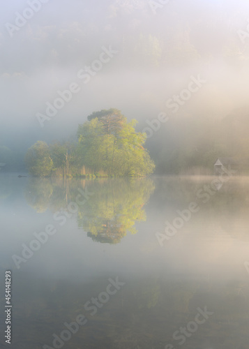 Boathouse With Misty Lake at Rydal Water, Lake District, UK.