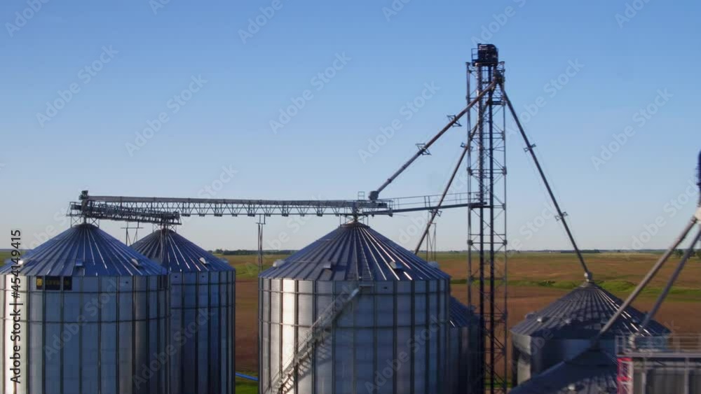 Drone Flying Towards Steel Grain Silos In Countryside Farm. - aerial Drone Flying Towards Steel Grain Silos In Countryside Farm. - aerial