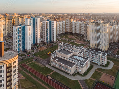 District of newly built colorful houses capable of accommodating thousands of residents.   lose location of multistorey buildings. Modern tall living dwellings in Russia. Saint Petersburg. Aerial view.
