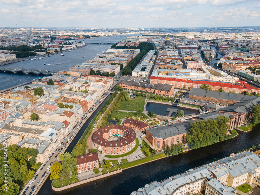 Aerial panoramic view of New Holland island flooded with sunlight. Place for recreation in St Petersburg. City center on the background. Bridges of Saint Petersburg. Russia in the summer.