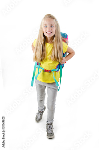 1-september concept. Back to school. Full length, legs, body, portrait, size vertical. Photo of small girl isolated on white background with backpack on shoulders 