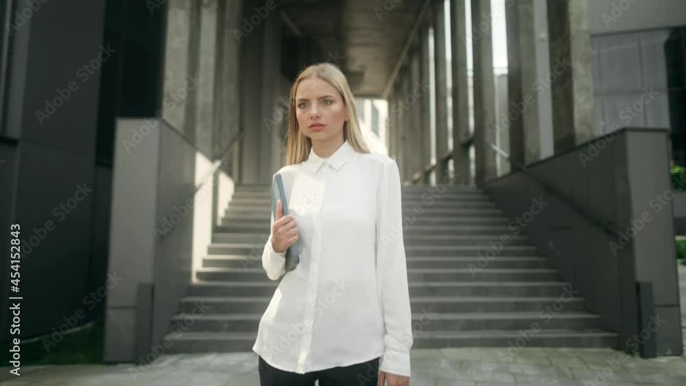 Successful young beautiful blonde woman with tablet walking downstairs at office building. Cooperation. Career. Attractive business girl Successful young beautiful blonde woman with tablet walking downstairs at office building. Cooperation. Career. Attractive business girl