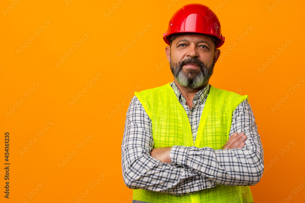 Portrait of senior construction worker in yellow vest in studio Portrait of senior construction worker in yellow vest in studio