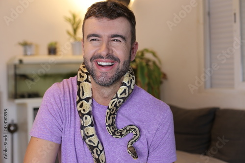 Man holding "python regius" or "ball python"