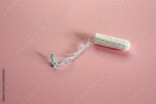 clean cotton tampon on pink paper texture